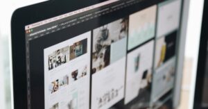 A modern computer screen displaying web design work, showcasing creative visuals in a workspace.